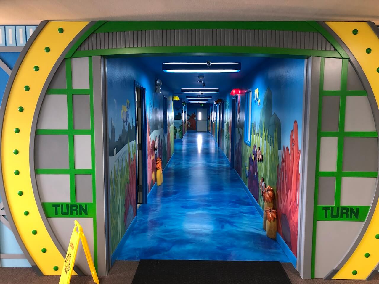 Underwater themed epoxy floor in a church nursery.  This floor has a sky blue base and deep blue highlights