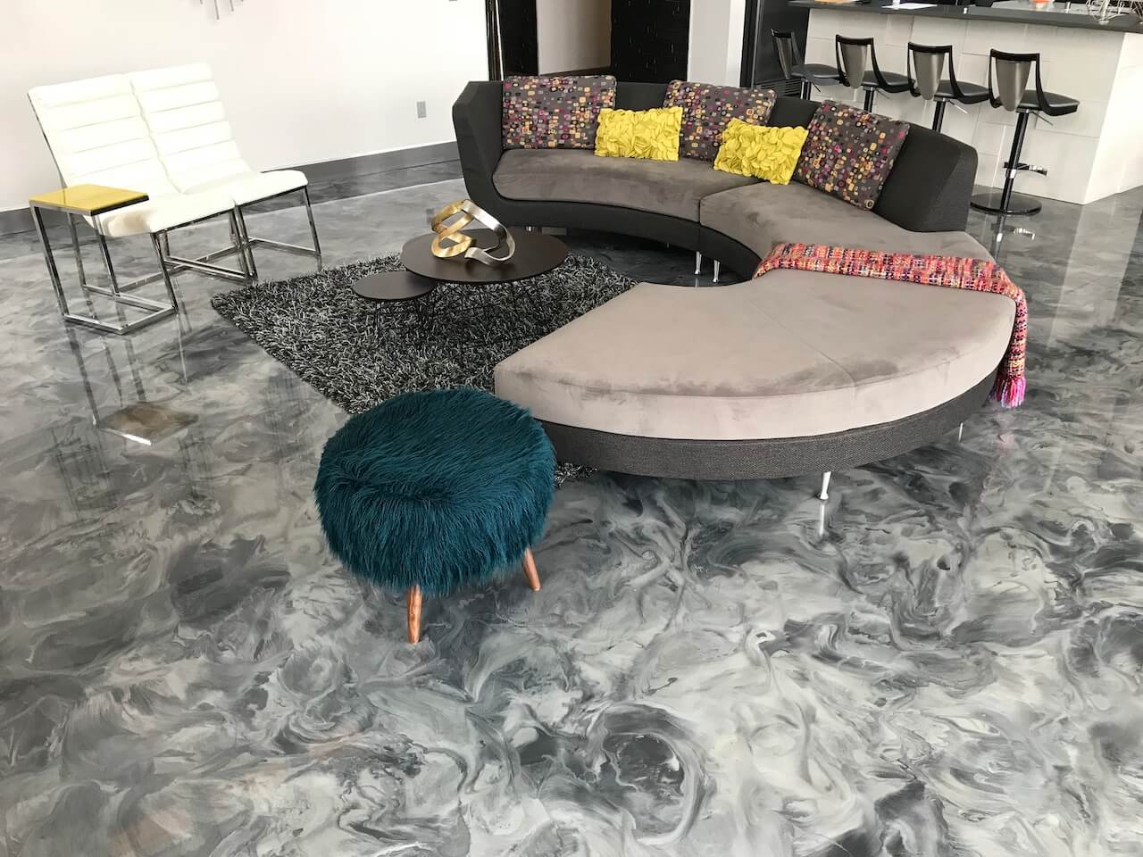 Beautiful gray, black, and white metallic epoxy floor in the main living area of a modern home.  