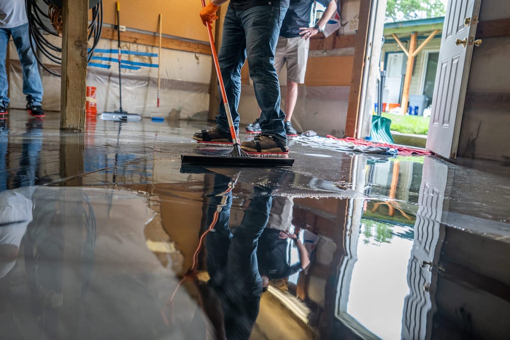 Spreading metallic epoxy in a garage.