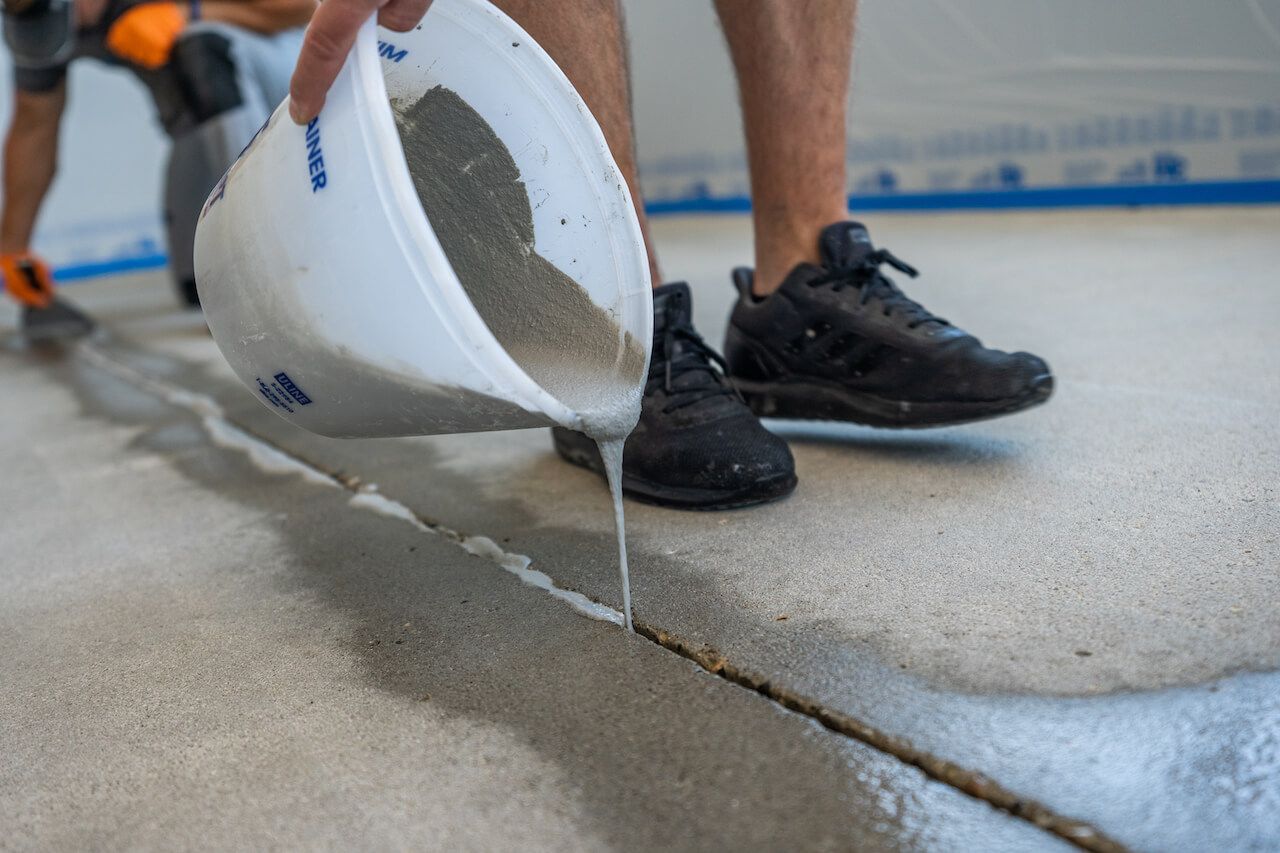 Concrete cracks being filled with a crack filler.